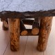 Mesa centro piedra y patas con troncos